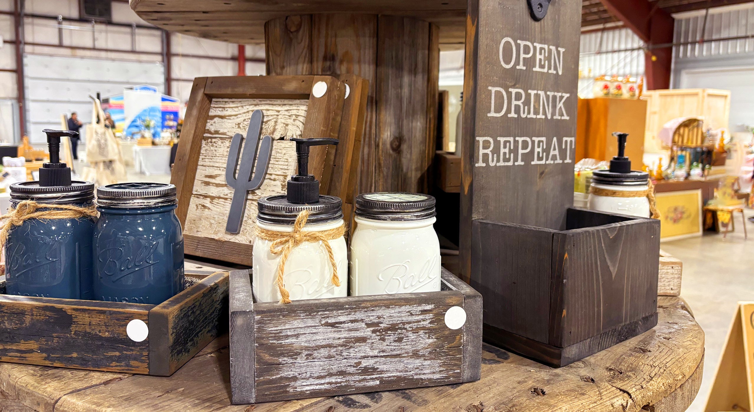 Decorative items including jars, a sign, and a cactus decoration on a wooden shelf.