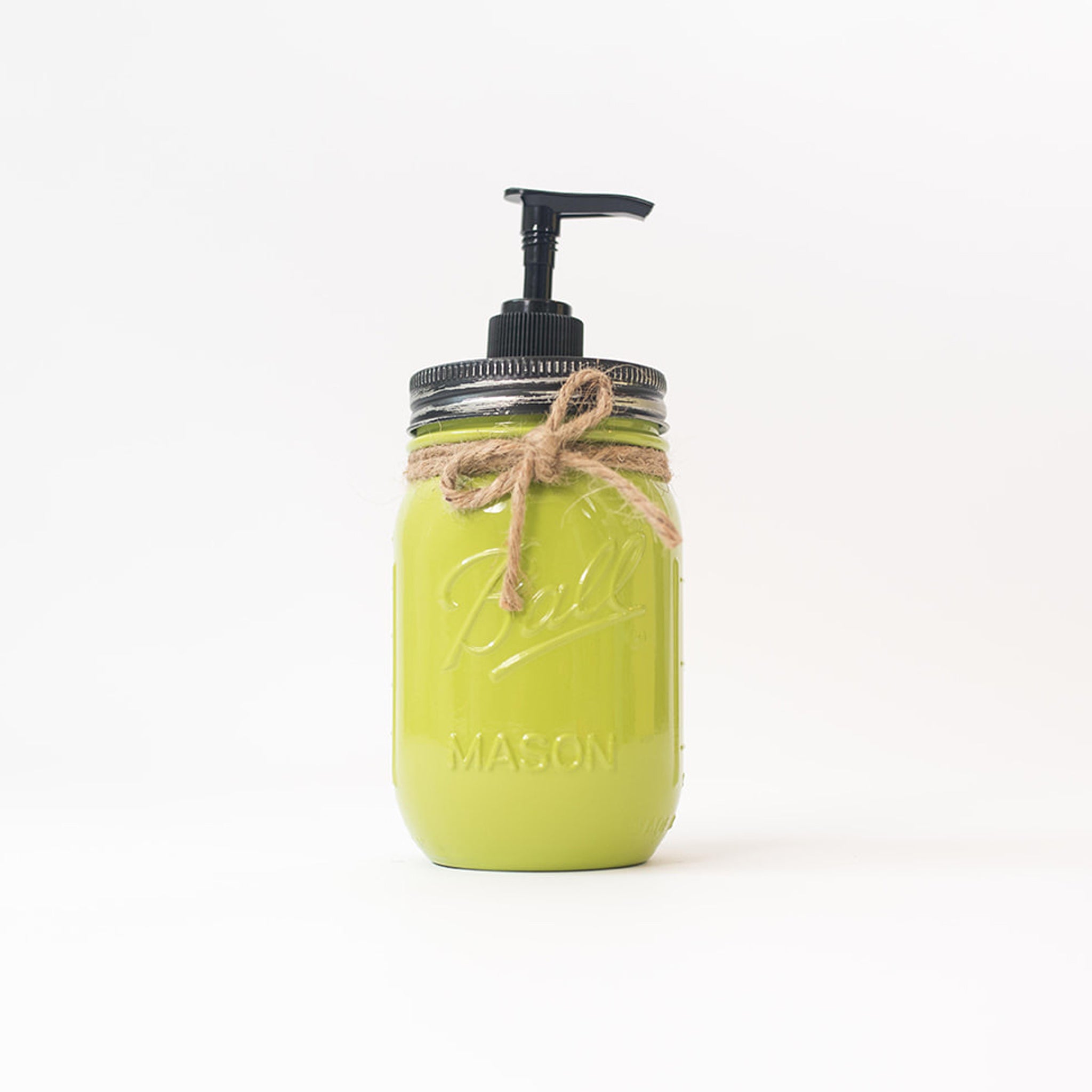 A green mason jar soap dispenser with a pump on a white background.