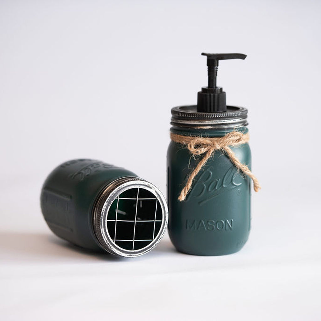 Green mason jars, one with pump dispenser on a white background.