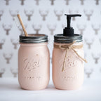 Two mason jars, one with a toothbrush and the other with a pump dispenser, on a neutral background.