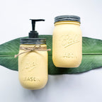 Two mason jars with metal lids on a white background.