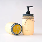 Mason jar soap dispenser and toothbrush holder on a white background.