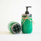 Green mason jar soap dispenser with pump on a white background.
