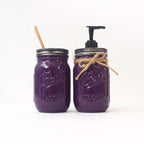 Two purple mason jars with a straw and pump dispenser on a white background.