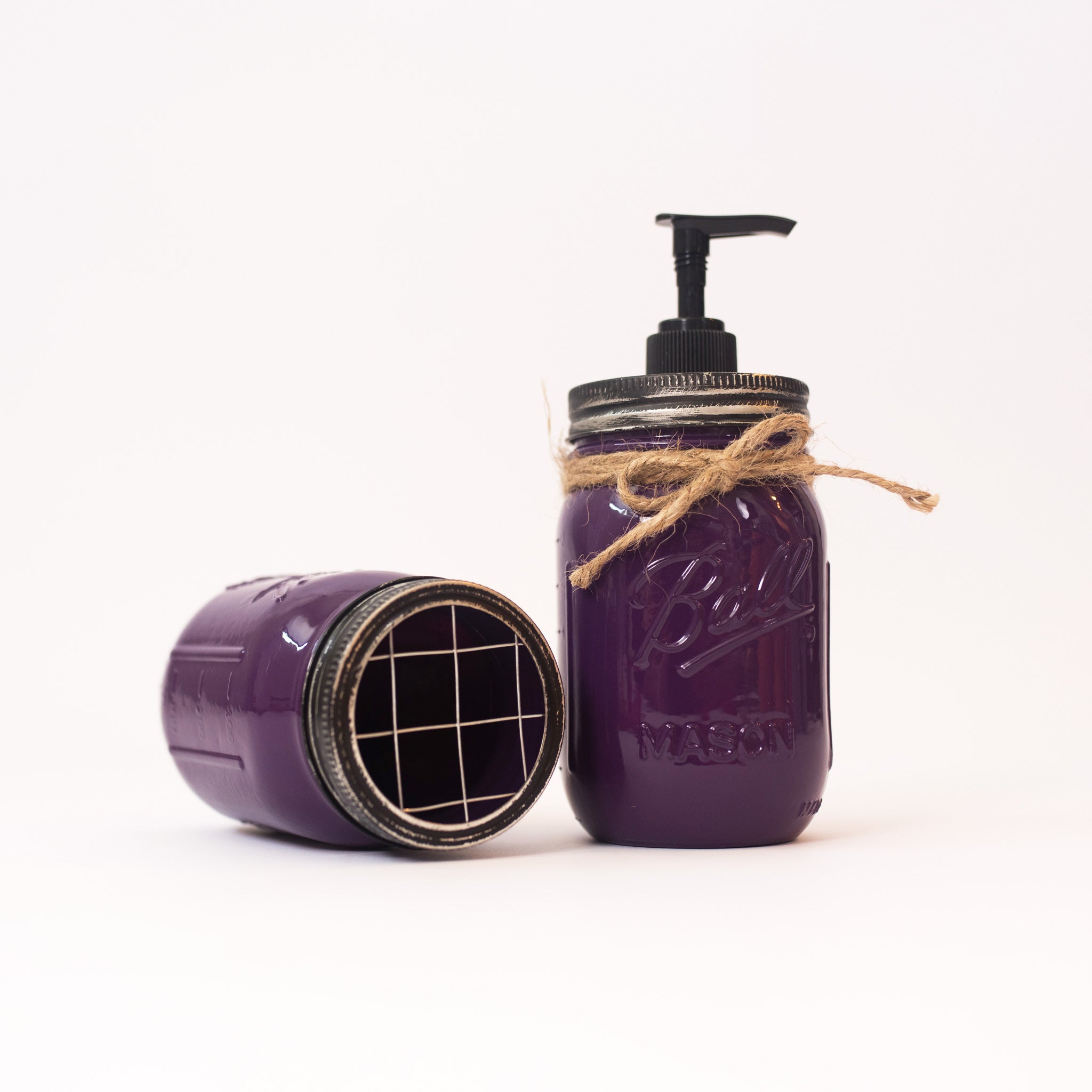 Purple mason jar soap dispenser with pump on a white background.