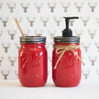 Two red mason jars with a brush and pump dispenser on a deer head pattern background.