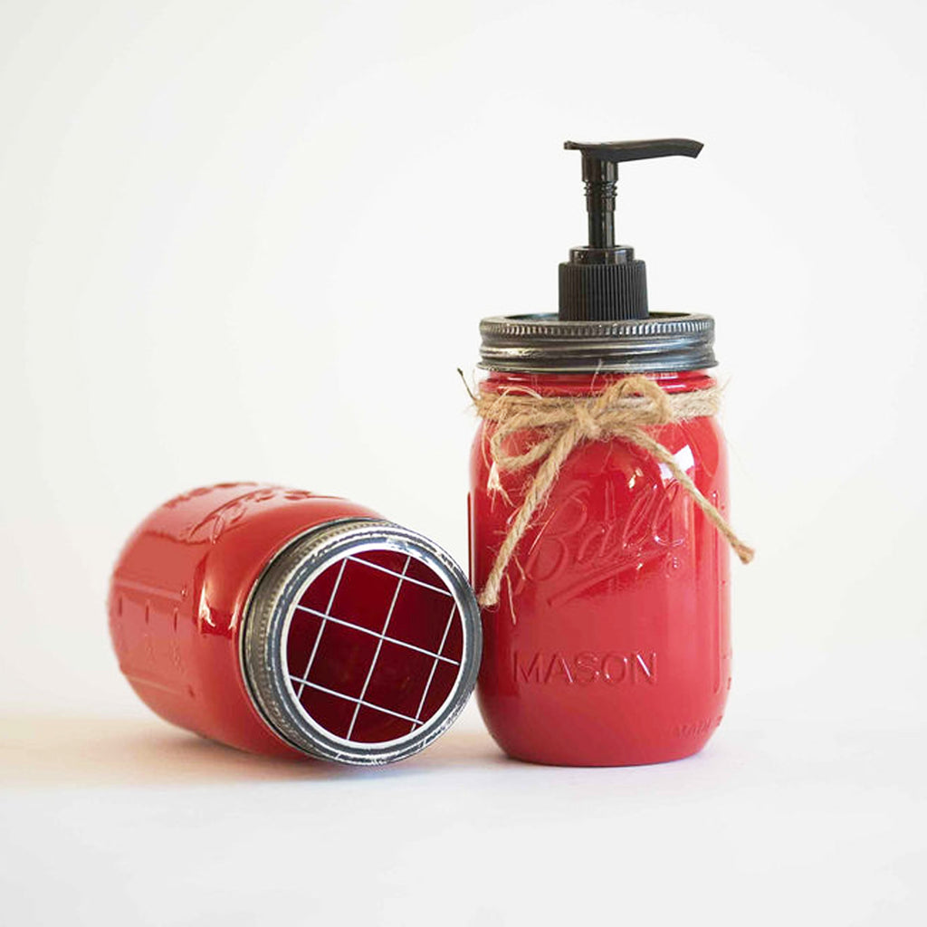 Red mason jar soap dispenser with pump on a white background.