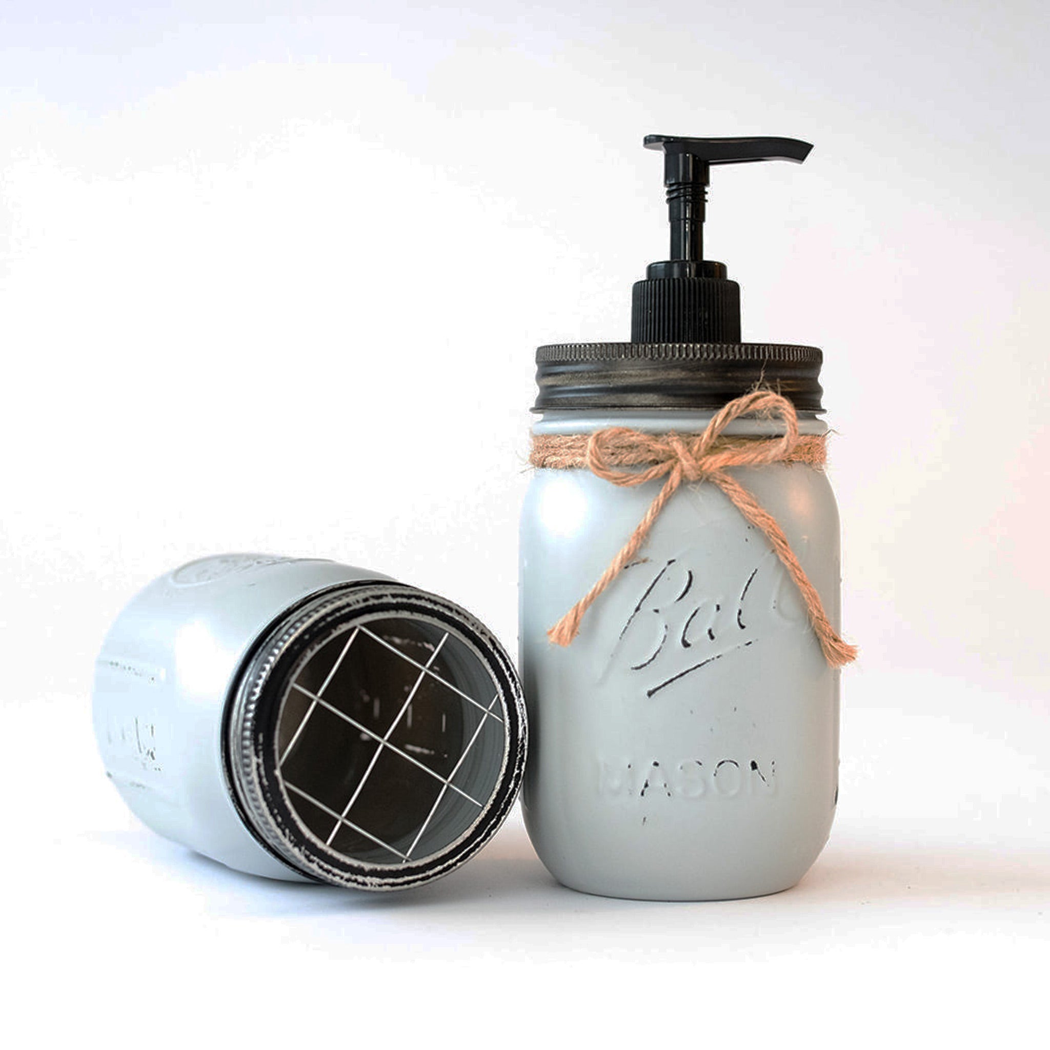 Mason jar soap dispenser with pump and lid on a white background.