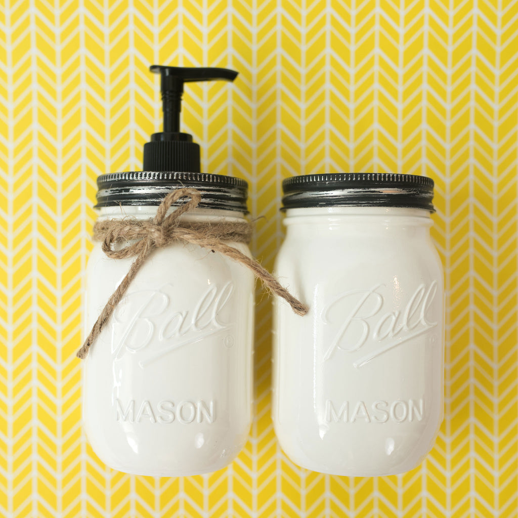 Two white mason jars with black lids on a yellow and white chevron patterned background.