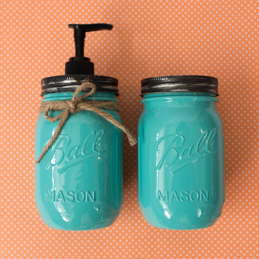 Two turquoise mason jars with black lids on an orange polka dot background.