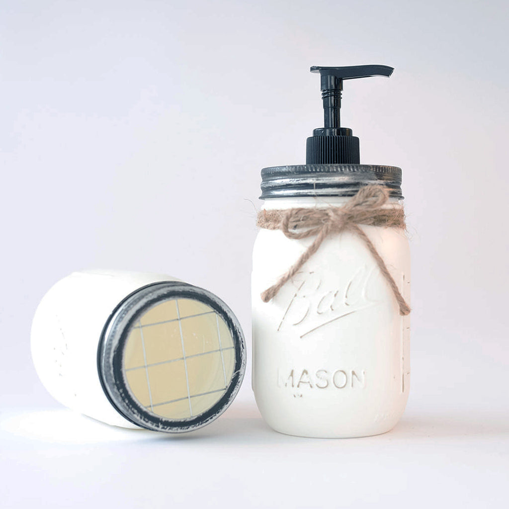 Mason jar soap dispenser with pump and lid on a white background.